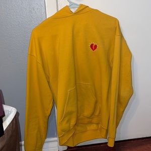 Yellow hoodie with red broken heart